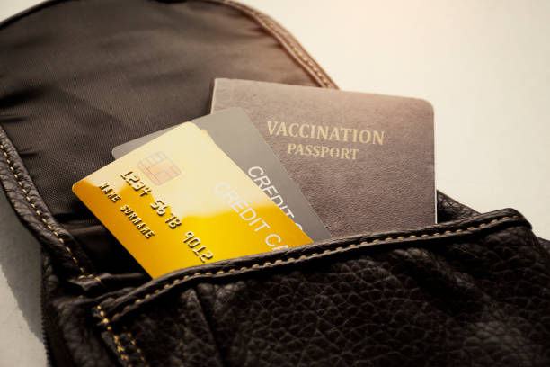 Credit card and vaccination passport for international travel in leather bag